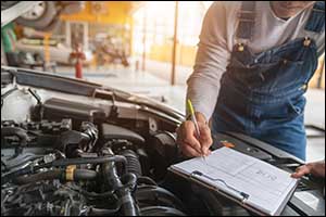 man writing car maintainence list