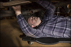 mechanic beneath the car