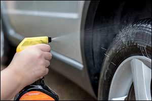 man cleaning tyres