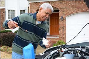 happy man checking engine oil