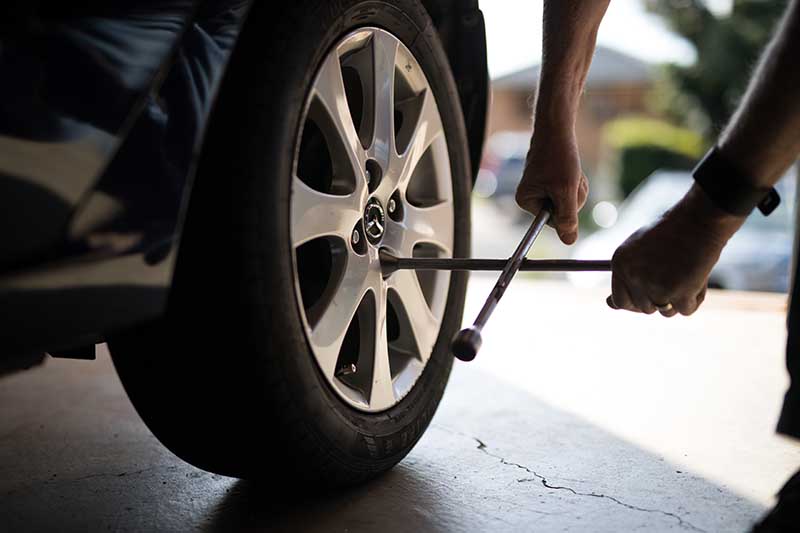 man unlocking tyre