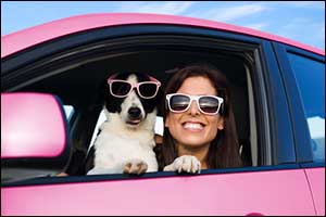women with his dog in a pink car
