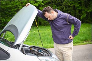 worried man checking his vehicle