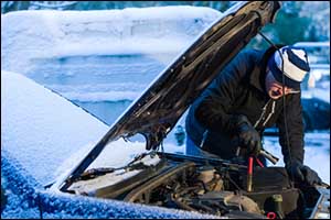 man checking his car in winters